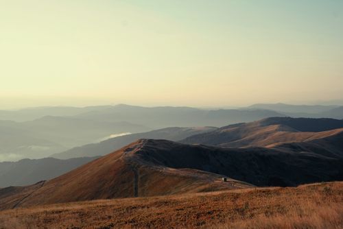 Free Capture of a scenic mountain range at golden hour showcasing brown hues and serene beauty. Stock Photo