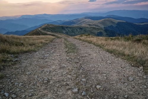 Free A scenic view of a rocky trail leading through mountains at sunset in Ust-Czorna, Ukraine. Stock Photo
