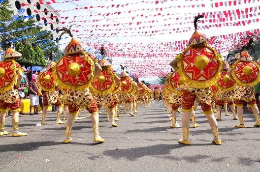 A lively street festival with costumed dancers in a parade, showcasing cultural celebrations.