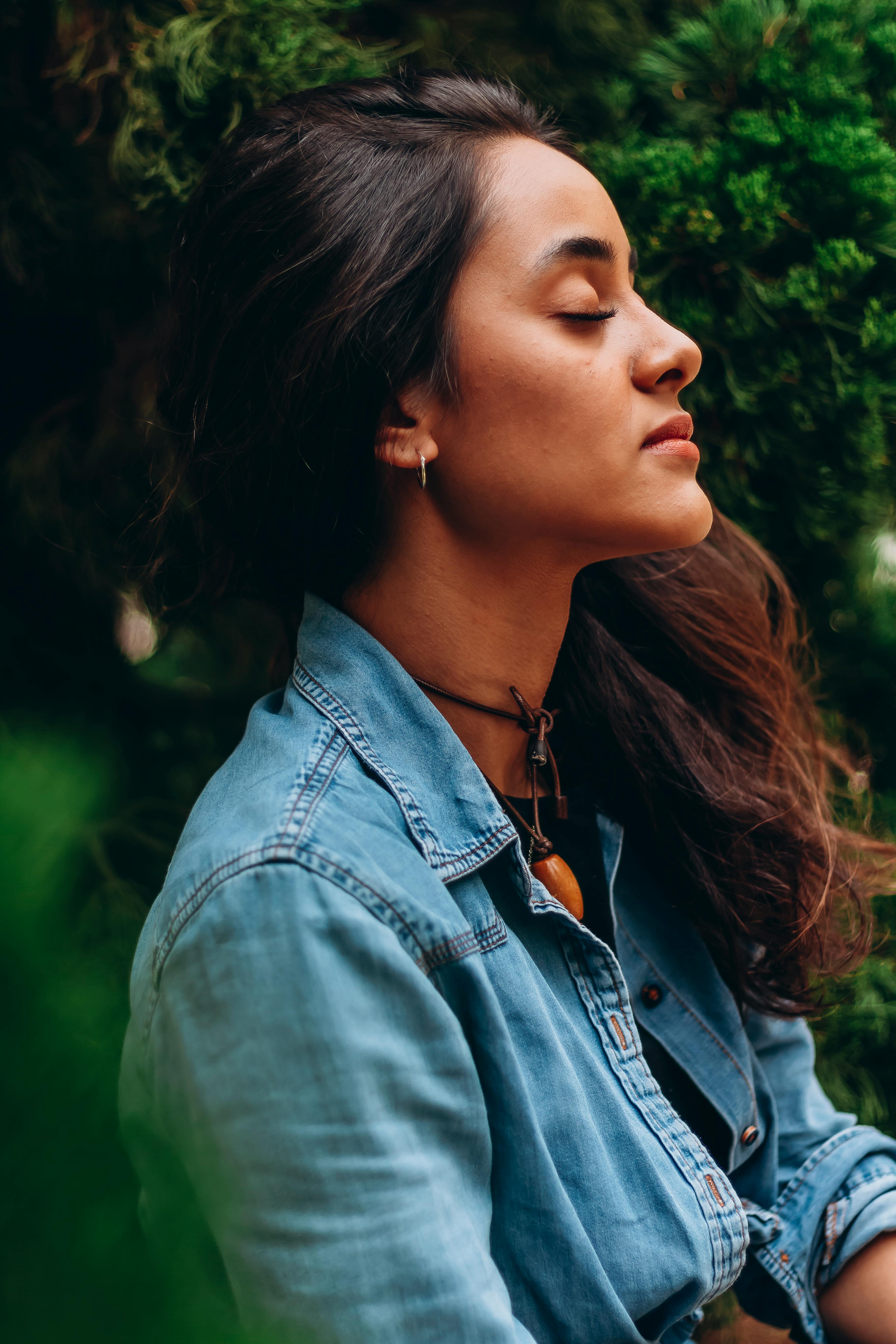 Photo of Woman in White Dress Shirt, Maroon Bra, and Blue Denim