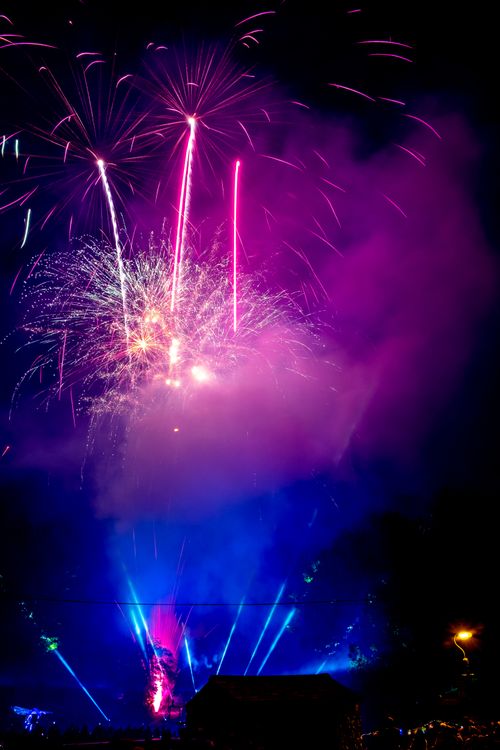 Free Colorful fireworks exploding in the night sky, creating a mesmerizing spectacle with vivid colors and smoke. Stock Photo