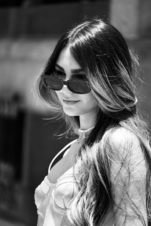 Grayscale Photo of Woman Wearing Sunglasses