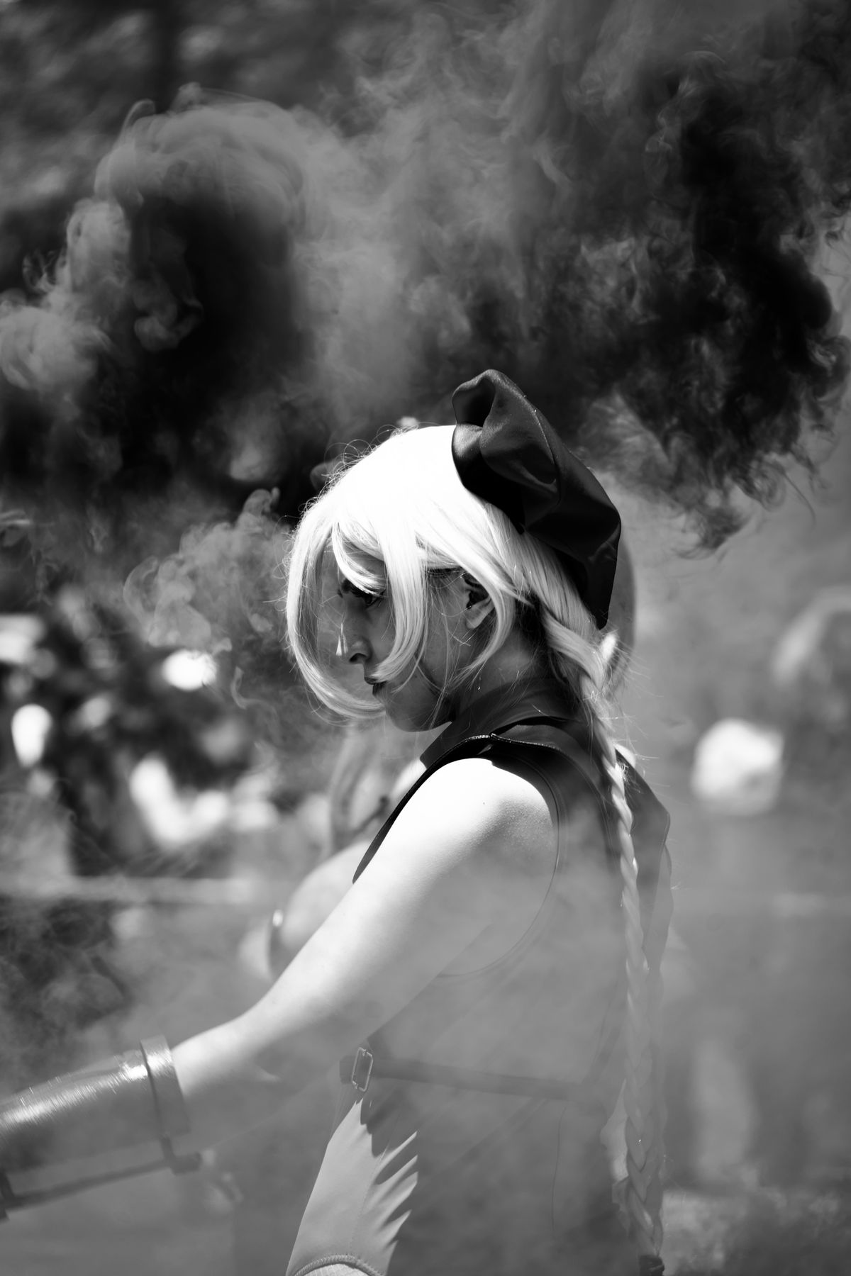 Dramatic black-and-white cosplay portrait with smoke effect