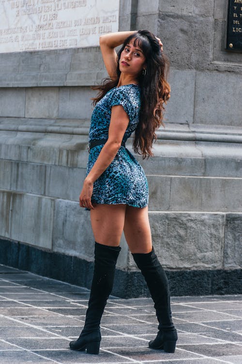 Woman in Short Dress and Boots Looking Back