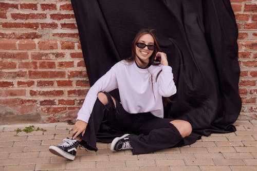 Stylish Woman in Black Sunglasses and Purple Sweater 