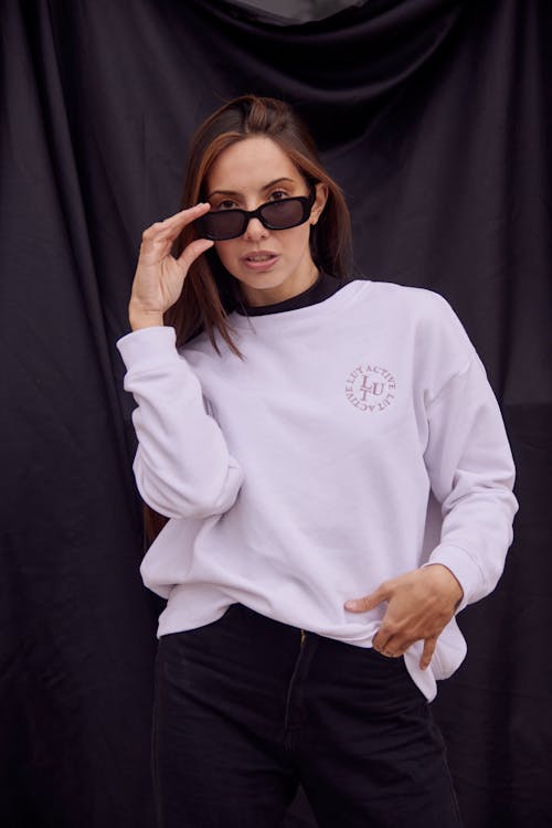 Woman in White Sweatshirt Wearing Sunglasses