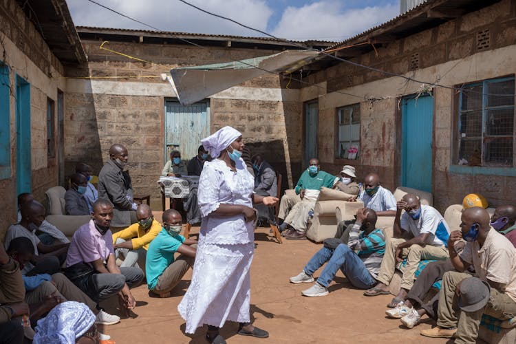 People In Face Masks In Poor Africa Village