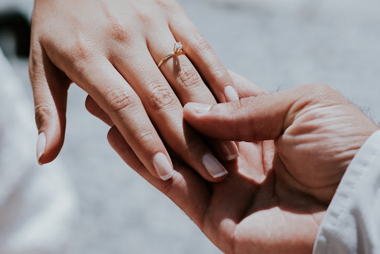 Hand Holding Fingers With Ring