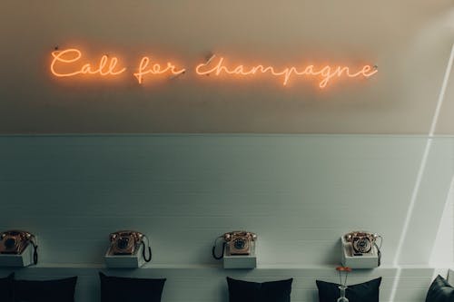 Lighted Yellow Call for Champagne Signage