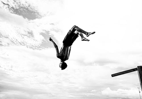 Free A Shirtless Man Jumping Upside Down Stock Photo