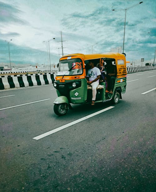 Free Auto Rickshaw on highway Stock Photo