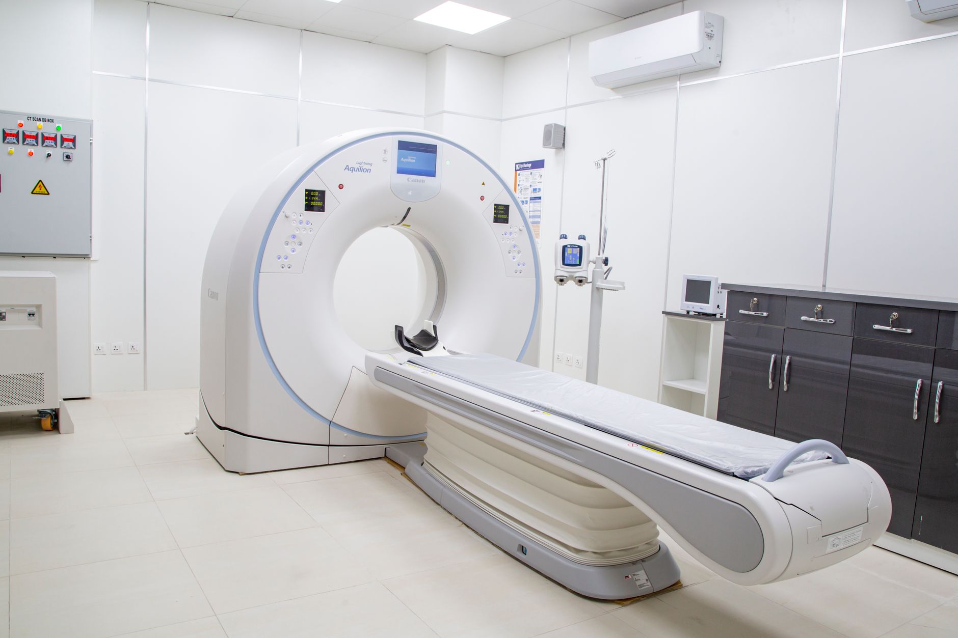 High-resolution image of a modern, clean MRI scanner room in a hospital facility.