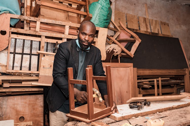 Carpenter Working In Workshop