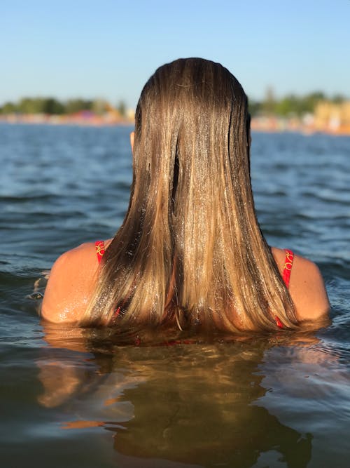 Woman in Red Bikini Top on Water