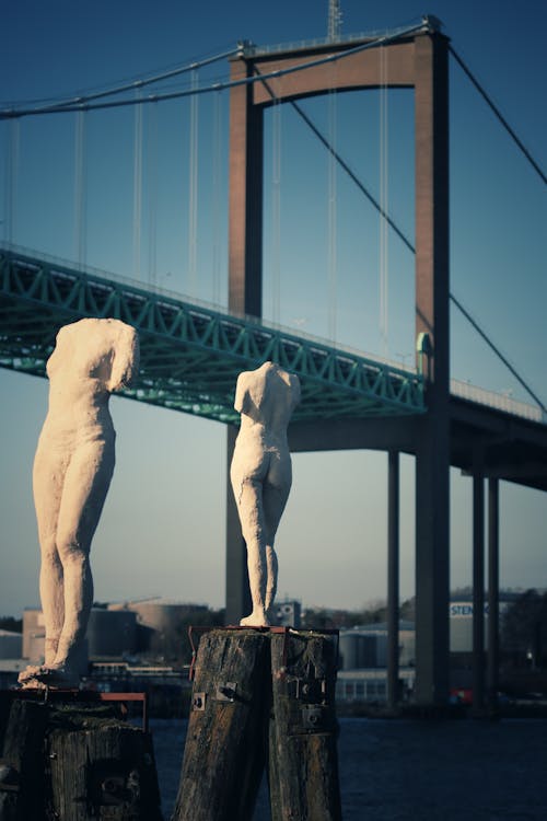 White Concrete Statue Near Bridge