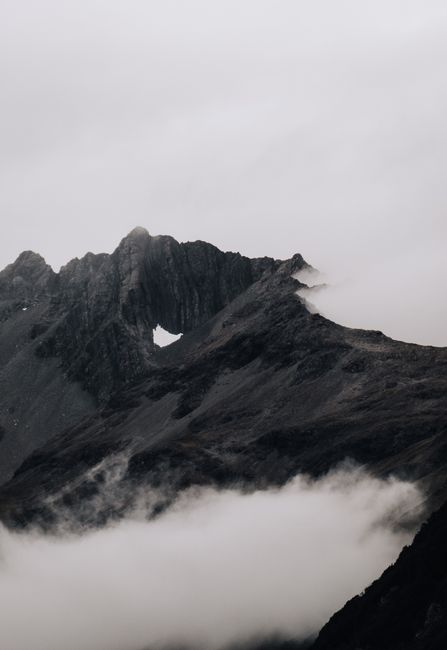 Capture the essence of New Zealand with this fog-covered rocky mountain landscape. Perfect for nature lovers.