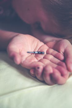 Child's hands holding a small toy car with a focused and serene atmosphere.