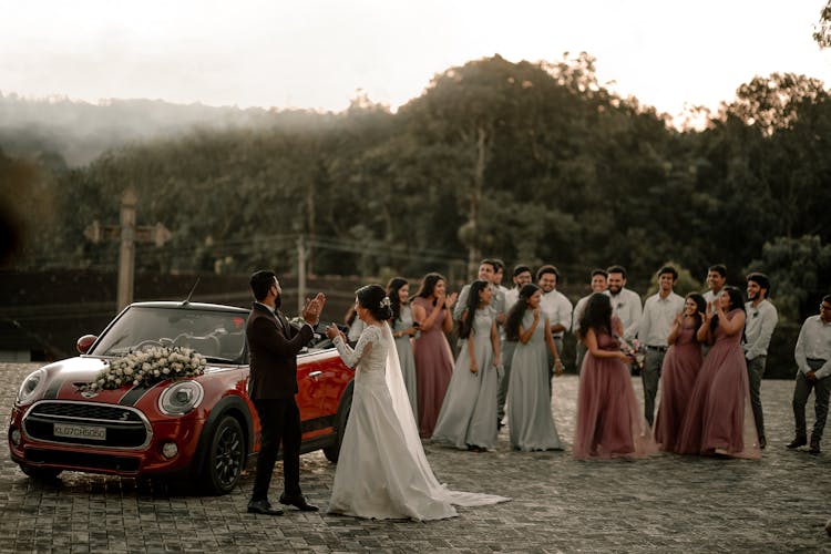 Bride And Groom Near Car On Wedding Ceremony