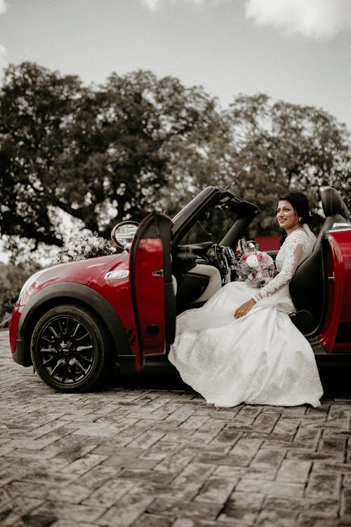 A Woman Wearing Wedding Dress Sitting in the Car 