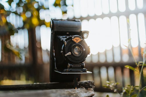 Free Black Camera on Brown Wooden Table Stock Photo