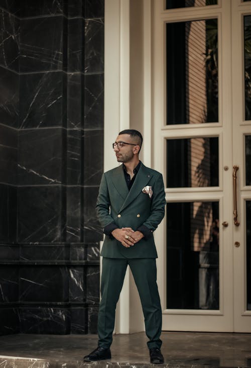 Man in Green Suit Standing near Door