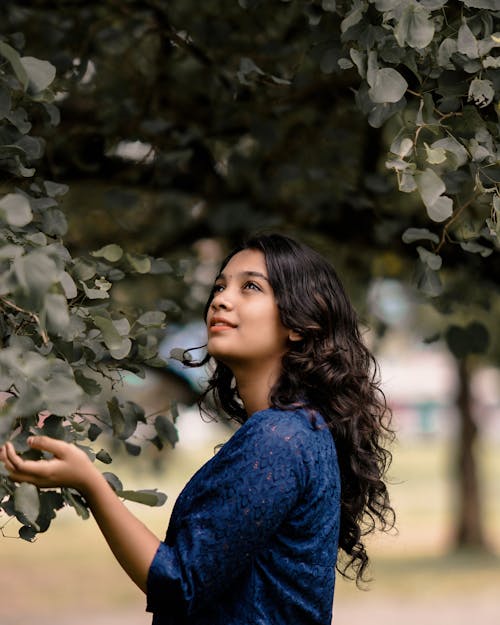 Photo of Woman standing Near a Tree