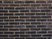 A Wall Made of Brown and Black Bricks