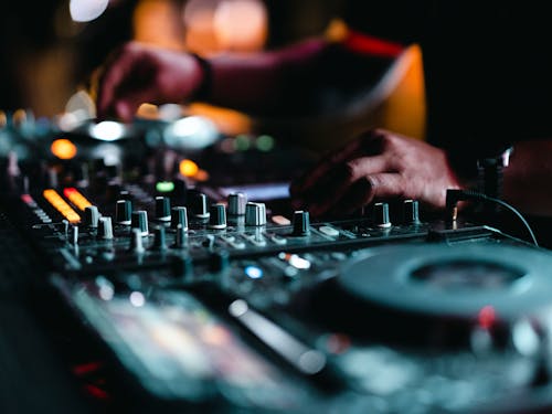 A DJ Controlling the Sound Mixer