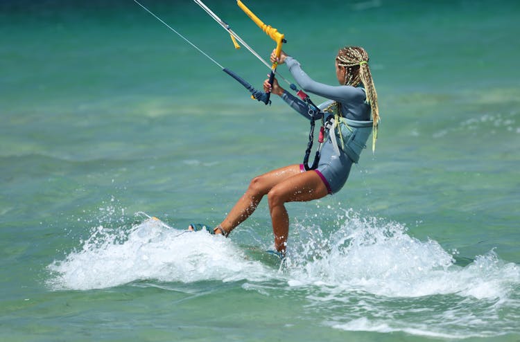 Braided Woman Doing Kitesurfing 