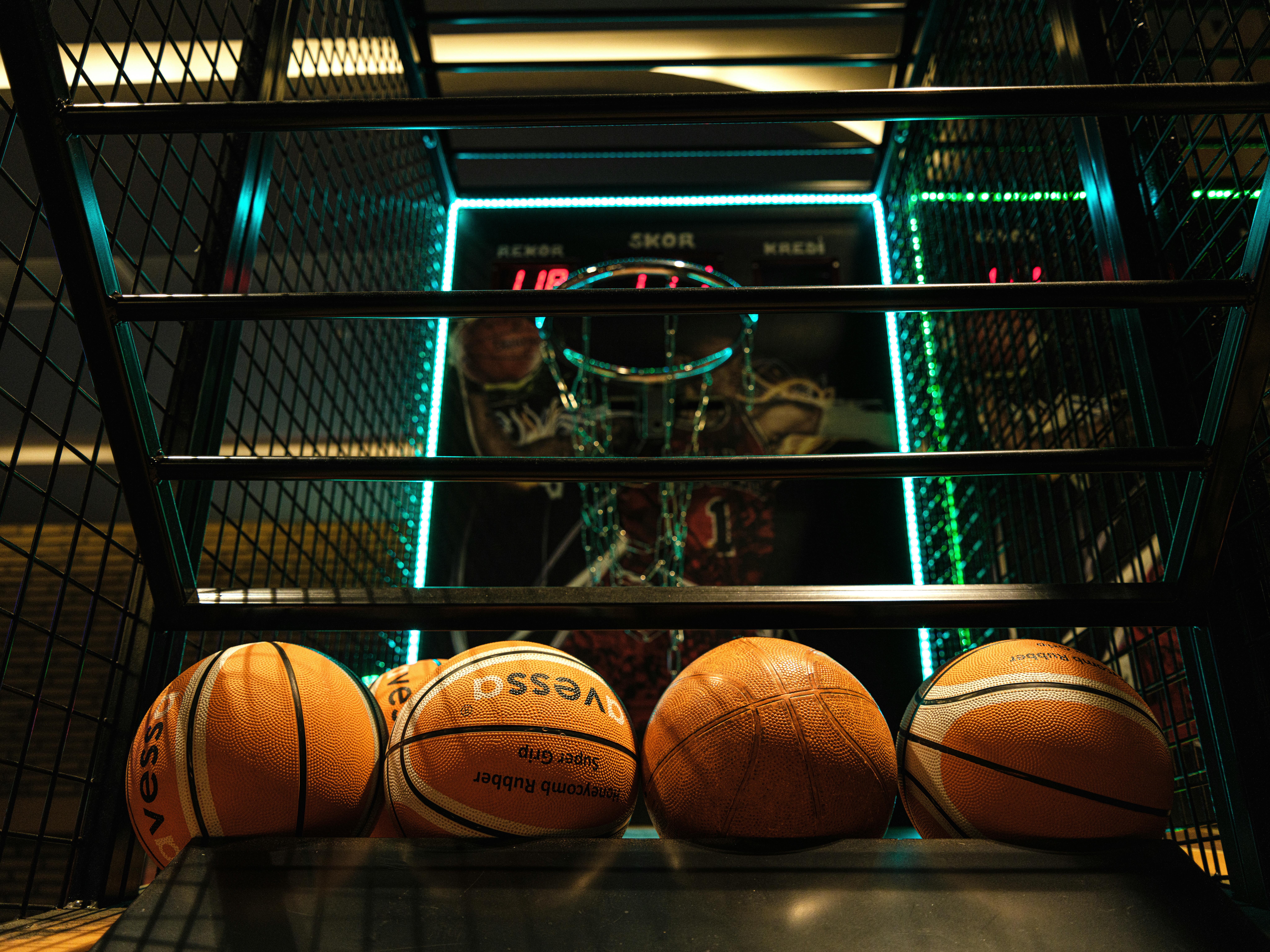 Close-up view of basketballs lined up for an arcade basketball hoop game.