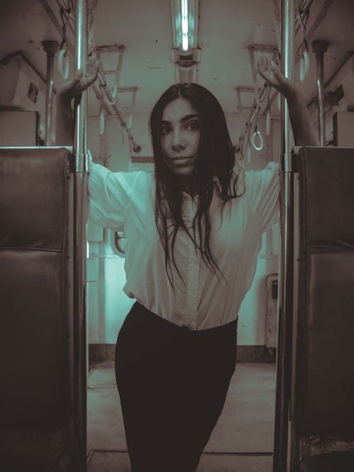 Woman in White Shirt on Metro Train