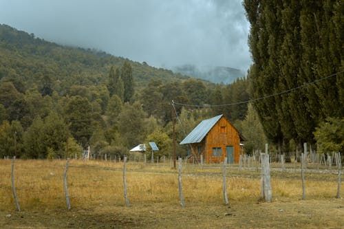 Wooden House in Countryside in Mountains Landscape