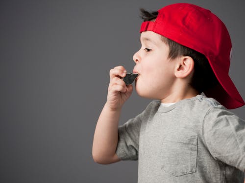 A Boy Blowing a Whistle 