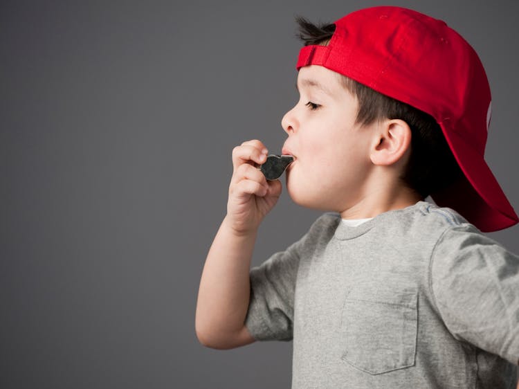 A Boy Blowing A Whistle 