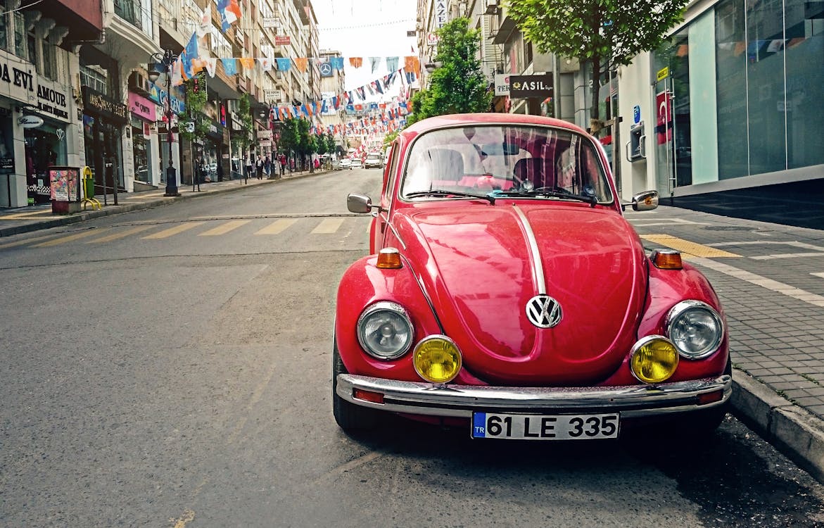 Red Volkswagen Beetle Parked at Road Side Near Pedestrian Lane