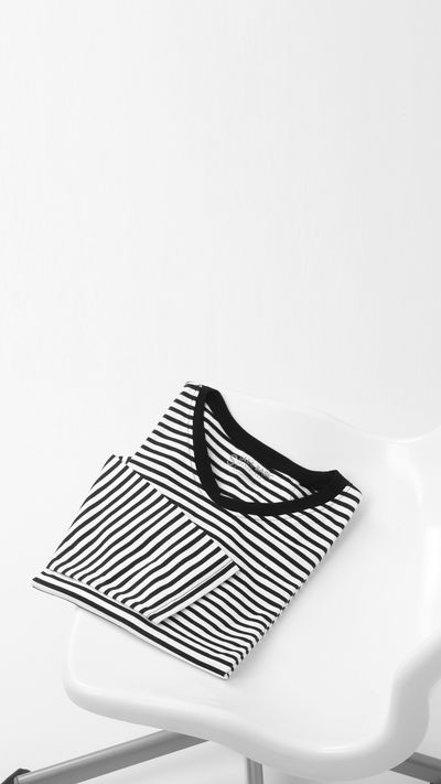 Folded black and white striped shirt — photo by Fahmi Garna on Pexels