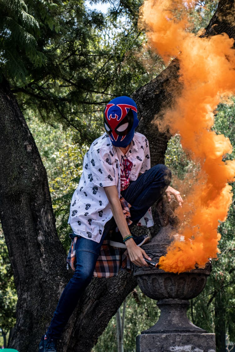 Person In Mask With Smoke Flare