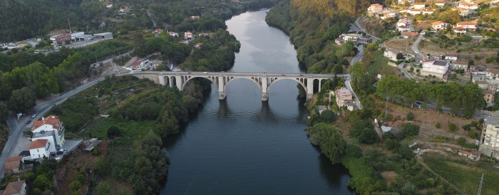A stunning aerial view of the historic bridge over the river in Porto, Portugal. Captured during daylight.