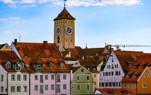 Free Charming view of Regensburg's clock tower and colorful townhouses under a blue sky. Stock Photo