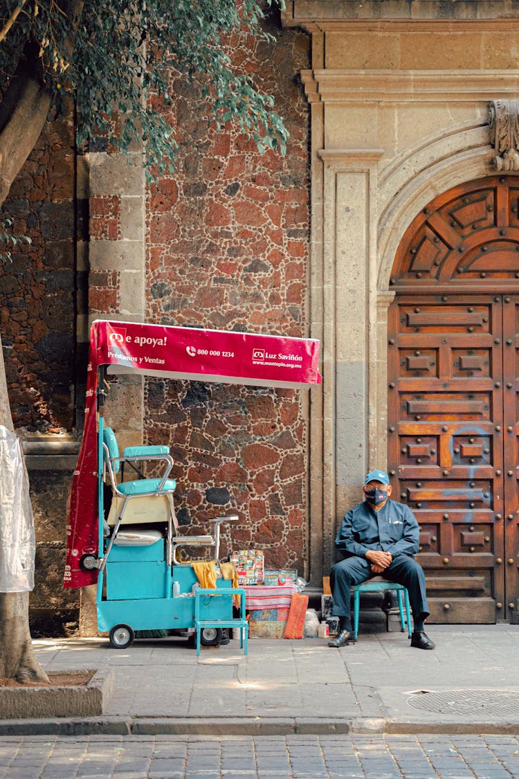 A Vendor Near Brown Wooden Entrance 