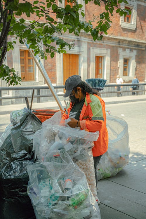 Person Collecting Garbage on Street