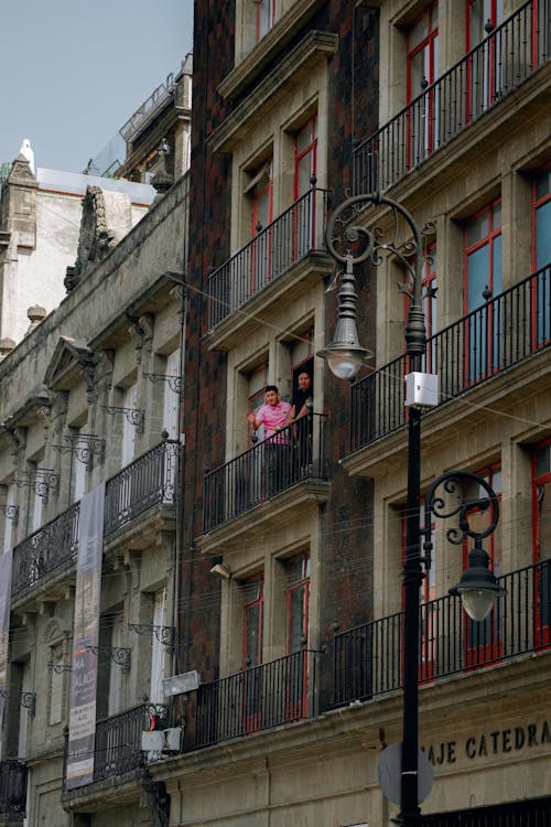 Men on a Balcony in a Building in City