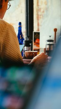 Casual atmosphere in a cozy café with a focus on a coffee cup and relaxed setting.
