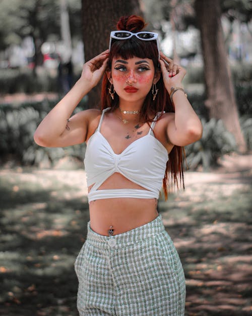 Pretty Woman in Crop Top Holding Her Head