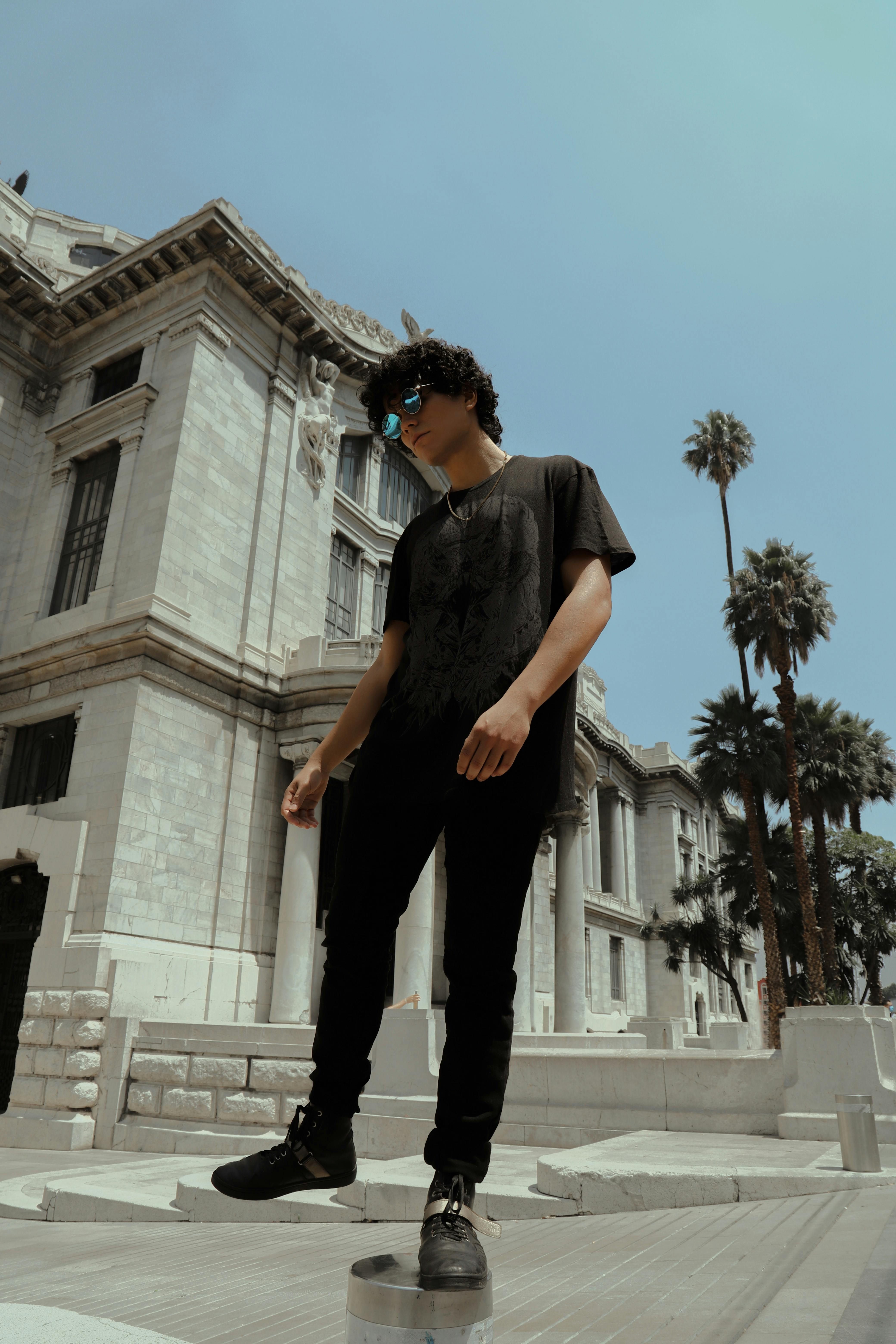 Man in Black T-shirt and Black Pants Standing Near a Mansion · Free ...