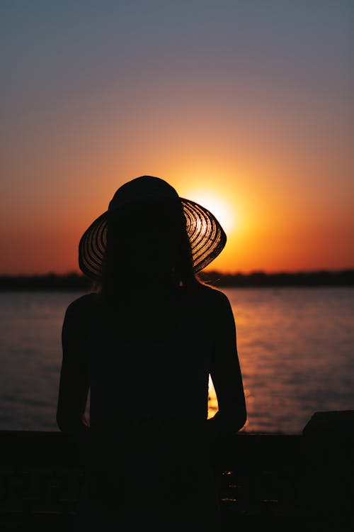 Silhouette of a Woman Wearing Sun Hat