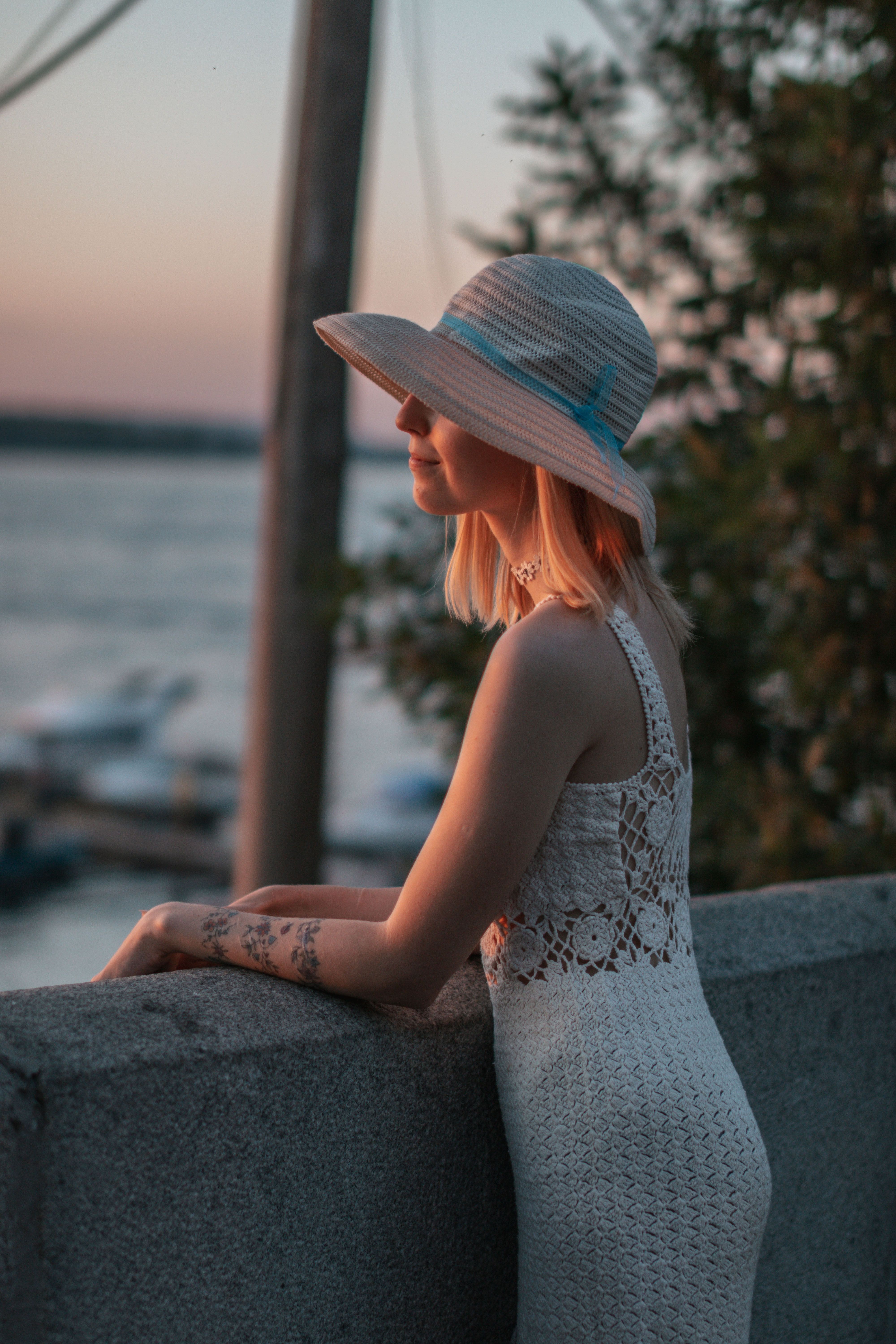 Woman in White Dress Leaning on Railing · Free Stock Photo