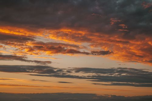 Free Stunning sunset with vibrant orange clouds against a serene sky. Stock Photo