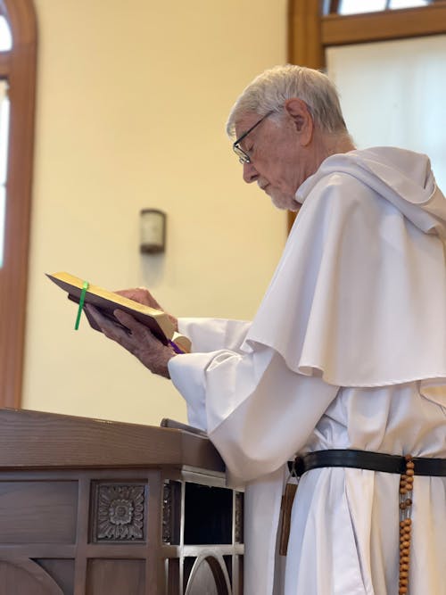 Elderly Priest During a Mass 