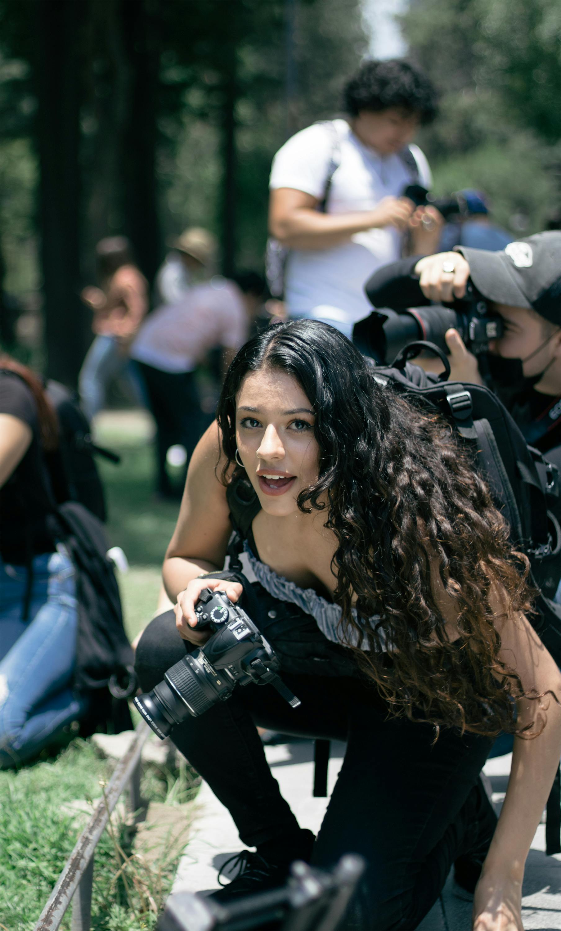 woman with camera crouching